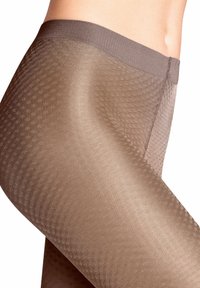 Collants marron avec un motif texturé, un design sans couture en haut et un matériau doux et transparent pour une apparence lisse.