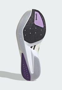 Sole di scarpa bianca e nera con motivi testurizzati, accentata in viola e dotata di fori di drenaggio. Caratterizzata da materiale leggero e un marchio distintivo.