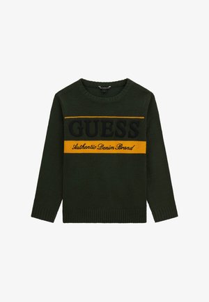 Maglione verde a maglia con maniche lunghe, scollatura rotonda, caratterizzato da un motivo a righe nero e giallo con il testo "GUESS" e "Authentic Denim Brand".