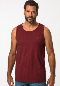 Burgundy sleeveless cotton tank top with a round neck and light stitching detail. Features a subtle "JP" logo on the front.