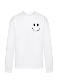 Valge pika varrukaga särk, millel on musta naeratava näo graafika ja tekst "GOOD VIBES CLUB" kaardus selle ümber vasakul rinnapiirkonnas.