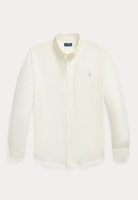 Chemise blanche à manches longues, boutonnée, avec col boutonné et petit logo brodé sur la poitrine gauche.