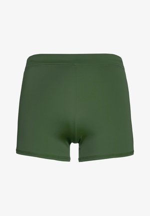 Pantaloni da bagno verdi realizzati in un tessuto morbido e elasticizzato. Presentano un design a vita media con un taglio dritto e cuciture piatte. Senza loghi visibili.