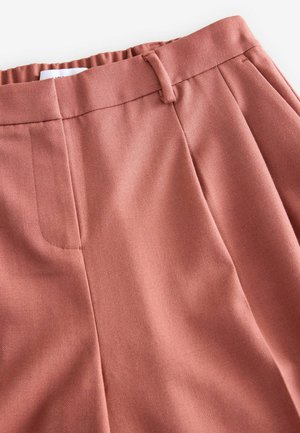 Růžové tailored kalhoty s hladkým a texturovaným povrchem. Mezi jejich vlastnosti patří plochý přední díl, boční kapsy a pas s poutky na opasek.