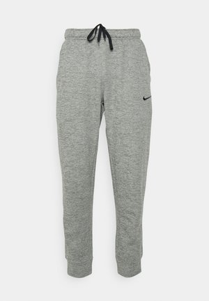 Gray Nike sweatpants with a drawstring waistband, tapered leg, and black logo on the left side. Soft, textured fabric with a heather pattern.