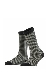 Schwarz-weiße gemusterte Socken mit gerippter Textur, featuring eine verstärkte dunkle Zehen- und Bündchenpartie, entworfen für Komfort und Langlebigkeit.