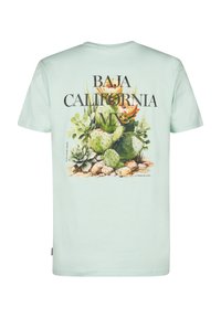 T-shirt vert menthe clair avec un graphique vibrant de cactus dans le dos, avec le texte "BAJA CALIFORNIA MX" affiché en évidence.