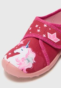Red fabric shoe with a pink strap, featuring a unicorn graphic and star patterns. The sole is pink and textured for grip.