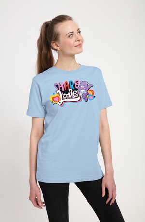 Lyseblå kortærmet t-shirt med et farverigt grafisk tryk med teksten "SHARE Love" og en lilla bjørneillustration. Lavet af bomuldsmateriale, afslappet pasform.
