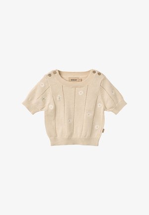 Pull bébé court à manches courtes en tricot beige avec une petite broderie de marguerite blanche, bords en côtes et détails de boutons sur l'épaule.