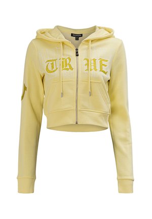 Sweat à capuche court jaune clair zippé avec poches avant, cordons et inscription brodée "TRUE" sur la poitrine et la manche.