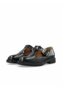 Black leather Mary Jane shoes with a rounded toe, cut-out sides, and a silver buckle accent on the strap. Flat rubber sole.