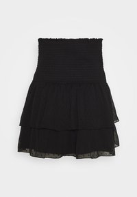 Falda mini negra de talle alto con volantes, cinturilla elástica con smock y capas de tela transparente con puntos.