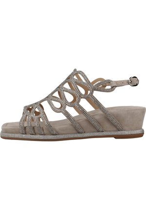 Wedge sandal in light beige with rhinestone accents, open design, and adjustable ankle strap. Soft texture with a smooth sole.