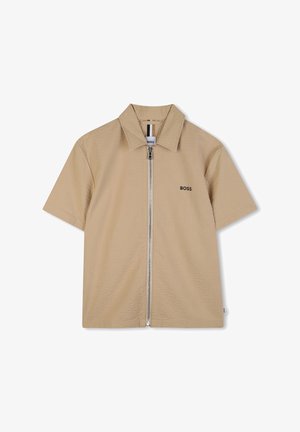 Camicia beige a maniche corte con tessuto strutturato, cerniera frontale e logo nero "BOSS" sul petto sinistro. Presenta un colletto.