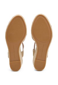 Light brown espadrille sandals with a textured fiber midsole, rubber outsole, and a wide strap design for stability and comfort.