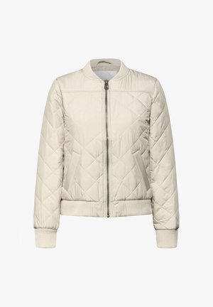 Veste bomber matelassée beige clair avec fermeture éclair à l'avant, poignets et ourlet côtelés, présentant une couture diagonale et des poches latérales.