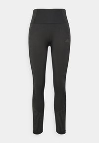Black athletic leggings with a high waistband, featuring textured stripes down the sides and a smooth fabric finish.