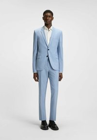 Light blue suit jacket and pants, featuring a subtle striped pattern. Paired with a white shirt and black shoes. Smooth texture.