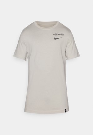 Light gray cotton t-shirt with short sleeves, featuring a small black Nike logo and a circular Spurs graphic on the chest.