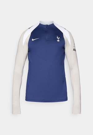 Nike Langarm-Trainingsoberteil mit einem marineblauen Körper, hellbeigen Ärmeln, einem Halb-Reißverschluss-Kragen und dem Spurs-Logo auf der Brust.
