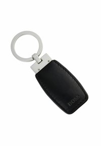 Czarny skórzany breloczek do kluczy o prostokątnej formie, z metalowymi elementami w kolorze srebrnym oraz wytłoczonym logo. Posiada okrągły uchwyt do kluczy.
