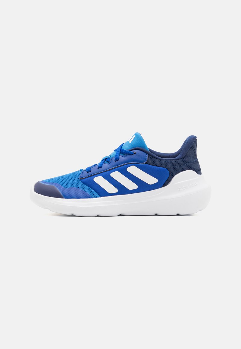 Blue athletic shoe featuring mesh and synthetic material, a rounded toe, white stripe accents, and a thick white sole for cushioning.