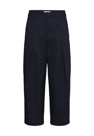 Pantalon large court bleu marine avec plis sur le devant, passants pour ceinture et une fermeture avant dissimulée.