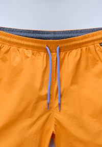 Shorts de bain orange vif avec une taille élastique, dotés d'une doublure grise et de cordons de serrage bleus. Tissu texturé avec un éclat subtil.