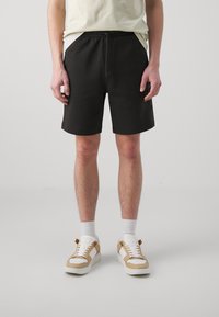 Calvin Klein Jeans LOGO REPEAT - Pantalones deportivos - black