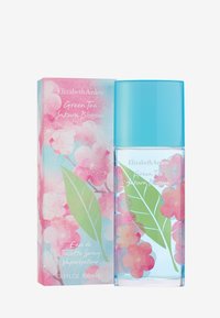 Transparent glasflaska med ett gradient ljusblått lock, pryds av blommor och blad i rosa och grönt på en pastellbakgrund. Förpackningen inkluderar text.