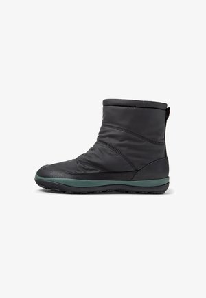 Stylish black mid-calf boot with a textured surface and green sole, designed for warmth and comfort in cold weather conditions.