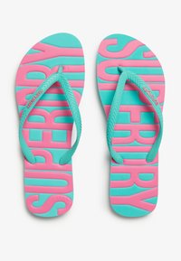 Lyserøde og turkise flip-flops med strukturerede såler, stort "SUPER" tekst, og gummistropper. Letvægtig design velegnet til casual brug.
