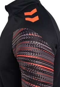 Svart träningsskjorta med hög krage, grå och röd mönstrad ärm med horisontella ränder och orange logotypdetaljer.