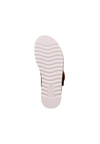 Shoe sole made of white rubber with wavy texture and subtle branding. The design is minimalist with no additional patterns or accents.