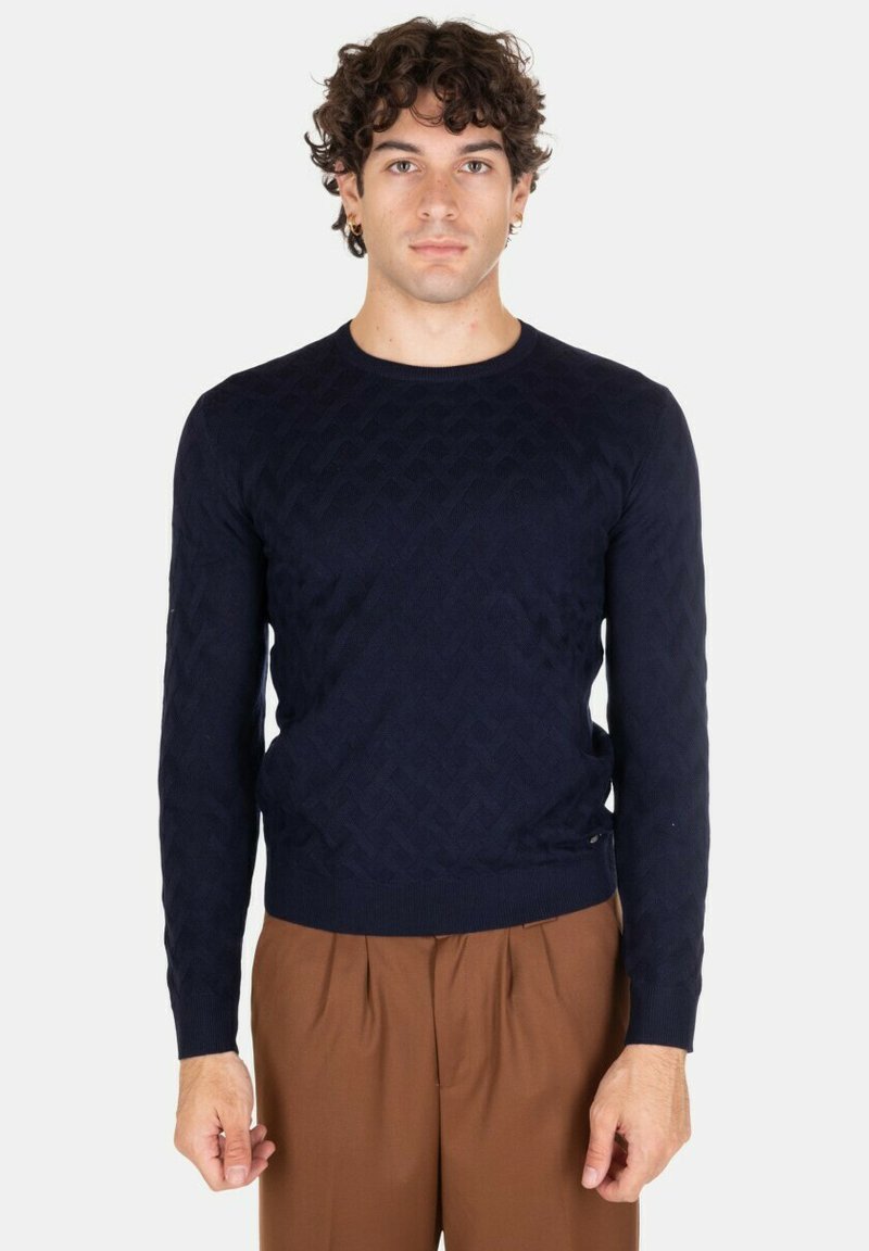 Maglione lavorato a maglia di colore blu navy con un motivo a diamante testurizzato, scollatura rotonda e polsini e orlo a costine. Vestibilità moderna e materiale morbido.