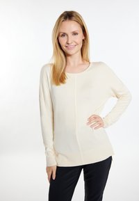 Cremfarbener Strickpullover mit langen Ärmeln, gerippten Bündchen und Saum. Verfügt über ein dezentes vertikales Linienmuster auf der Vorderseite.