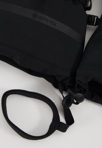 Schwarzer GORE-TEX-Stoff mit einem eleganten Design. Enthält einen Zugkordel, einen Plastikclip und einen Schlaufenriemen für einen sicheren Halt.