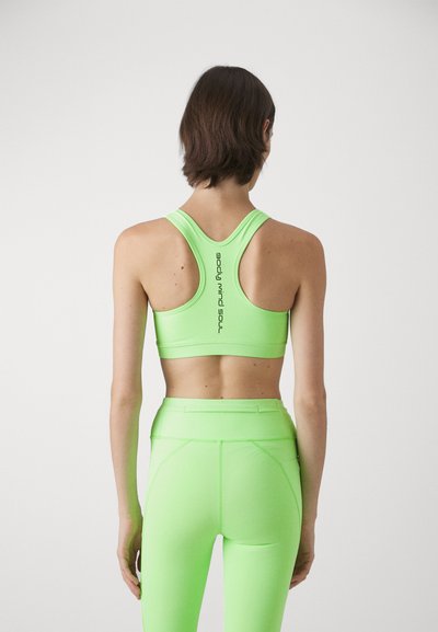 Neon green athletic tank top with a racerback design, displaying "soul" vertically on the back, paired with matching high-waisted leggings.