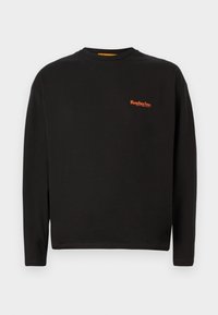 Black long-sleeve t-shirt made of cotton, featuring a small orange "Replay Inc." logo on the chest with a round neckline and standard fit.