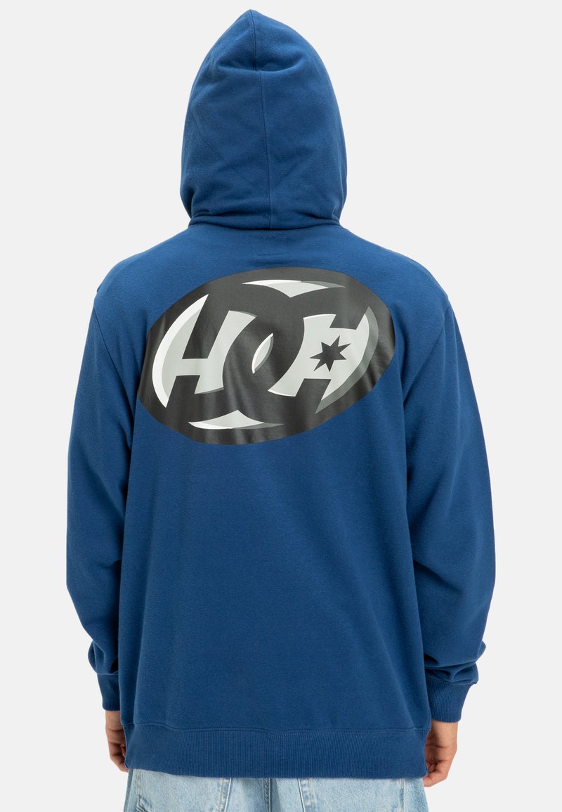 Blue hoodie with a large black and white logo on the back. Features a drawstring hood and ribbed cuffs and hem. Soft fabric texture.