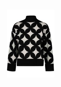 Black and white sweater with a high neckline, featuring a geometric pattern of overlapping circles and a solid black hem and cuffs.