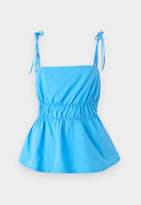 Light blue top with adjustable tie straps, fitted bodice, and flared peplum design; made of a smooth, lightweight fabric.