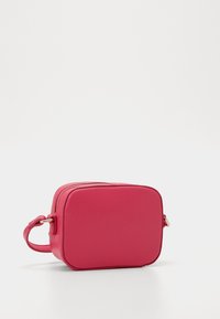 Rectangular pink leather crossbody bag with a textured surface, gold zipper, and a short strap. Compact design for easy carrying.