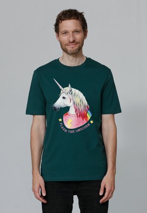 Dark green cotton T-shirt featuring a unicorn graphic with rainbow colors and text "FLASH THE UNICORN." Short sleeves, round neckline.