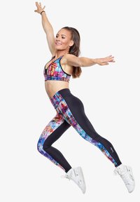 Kleurenset van sportbeha en leggings met een levendig abstract patroon en zwarte accenten. Gemaakt van rekbare stof, ideaal voor sportkleding.