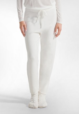 Weiße, weiche Fleece-Jogginghosen mit elastischem Bund und verstellbarem Kordelzug. Schmal zulaufendes Bein-Design mit gerippten Bündchen an den Knöcheln.