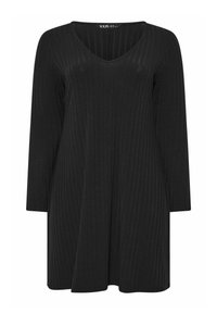 Vestido negro de canalé con escote en V y mangas largas. Silueta acampanada. Textura suave y diseño minimalista.