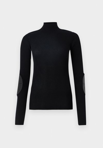 Mustpastline muströpul, millel on pikad varrukad ja nahast küünarpidemed, omab kitsast disaini ja siledat tekstuuri.