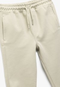 Lichtbeige joggers van textiel met een elastische tailleband, verstelbare koord en zijzakken.